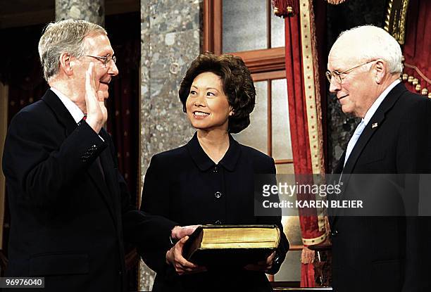 Senator Mitch McConnell, R-KY, is sworn in by Vice President Dick Cheney as his wife Labor Secretary Elaine Chao holds the Bible during a swearing in...