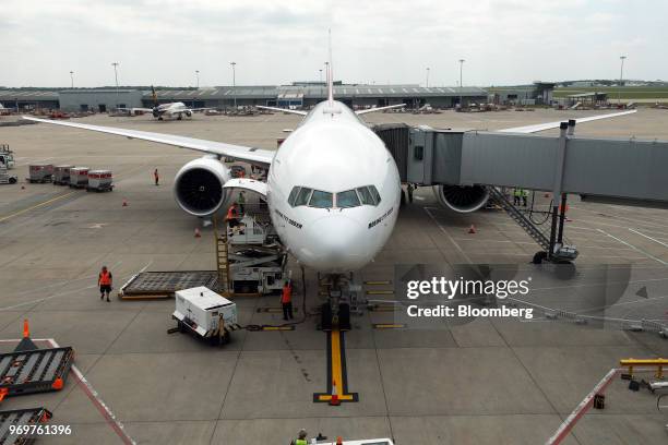 Boeing Co. 777-300ER passenger jetliner, operated by Emirates Airline, sits parked at its gate at London Stansted Airport in Stansted, U.K., on...