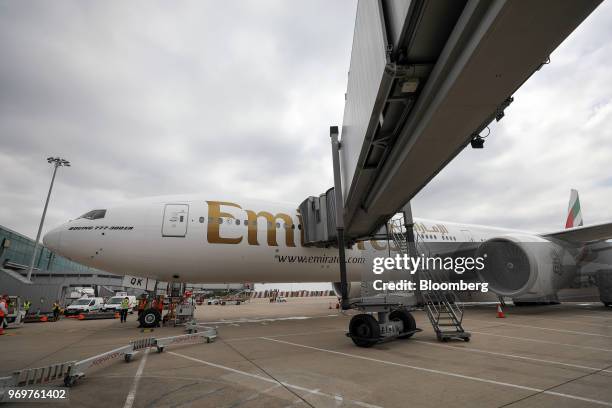 Passenger jetway bridge connects to a Boeing Co. 777-300ER passenger jetliner, operated by Emirates Airline, at London Stansted Airport in Stansted,...