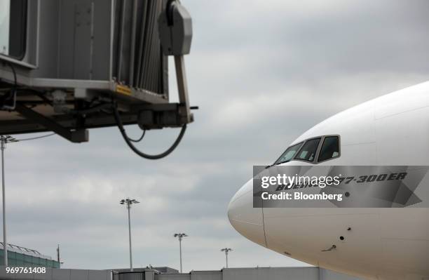 Boeing Co. 777-300ER passenger jetliner, operated by Emirates Airline, taxis to a passenger jetway bridge at London Stansted Airport in Stansted,...