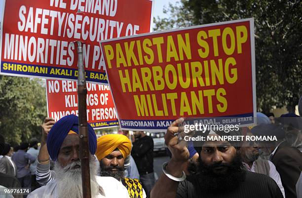 Members of the Shiromani Akali Dal hold placards during a protest against the killing of a Sikh in Pakistan, near the Pakistan Embassy in New Delhi...