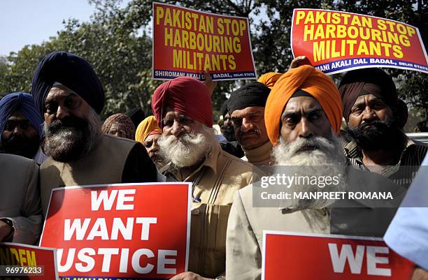 Members of the Shiromani Akali Dal hold placards during a protest against the killing of a Sikh in Pakistan, near the Pakistan Embassy in New Delhi...