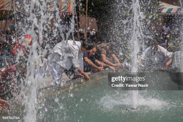 Kashmiri Muslims perform ablution on a pond before offering prayers inside the Grand Mosque on the last Friday of the holy Islamic month of Ramadan...