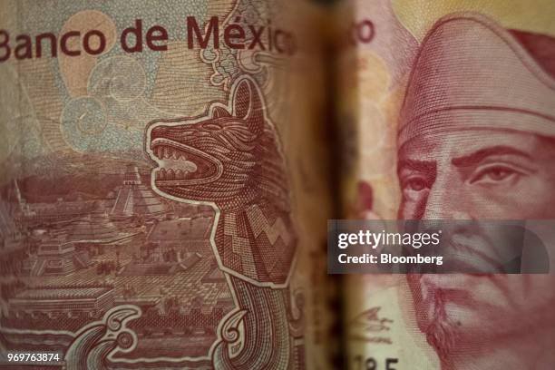 Mexican 100 peso banknotes depicting the image of poet Nezahualcoyotl, ruler of Texcoco, are arranged for a photograph in San Luis Potosi, Mexico, on...