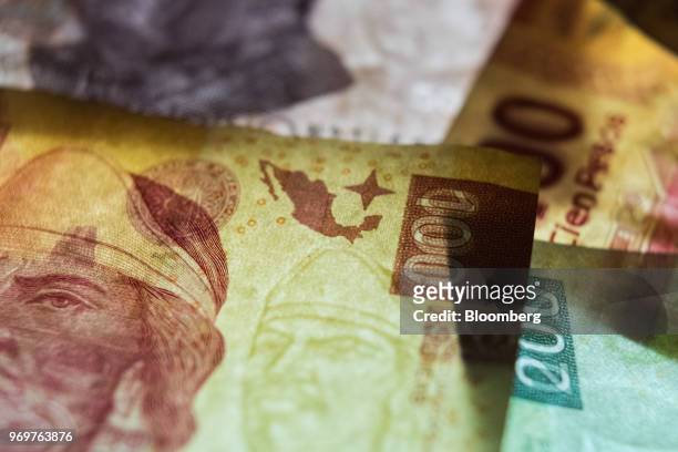 Mexican 100 peso banknotes depicting the image of poet Nezahualcoyotl, ruler of Texcoco, are arranged for a photograph in San Luis Potosi, Mexico, on...