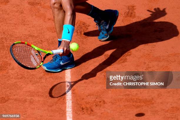 Spain's Rafael Nadal casts a shadow on court as he plays a backhand return to Argentina's Juan Martin del Potro during their men's singles semi-final...