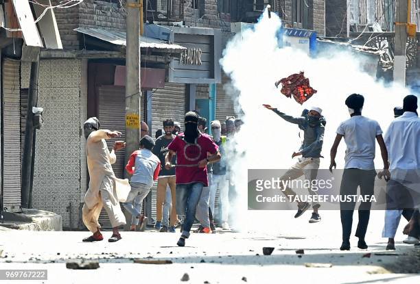 Kashmiri protestors and government forces clash after Friday prayers during the last Friday of Holy month of Ramadan in downtown Srinagar on June 8,...