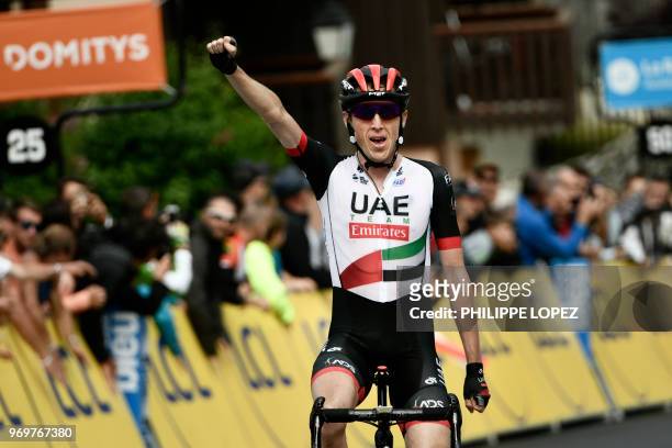 Ireland's Daniel Martin celebrates after crossing the finish line to win the fifth stage of the 70th edition of the Criterium du Dauphine cycling...