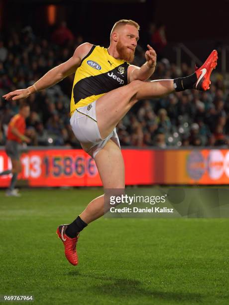Nick Vlastuin of the Tigers kicks the ball during the round 12 AFL match between the Port Adelaide Power and the Richmond Tigers at Adelaide Oval on...