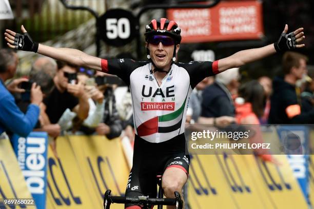 Ireland's Daniel Martin celebrates after crossing the finish line to win the fifth stage of the 70th edition of the Criterium du Dauphine cycling...
