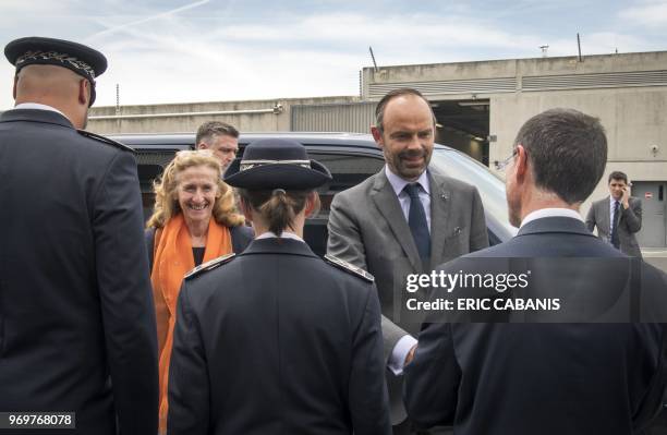 French Prime Minister Edouard Philippe and French Justice Minister Nicole Belloubet salute members of the penitenciary administration as they arrive...