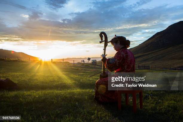 Munkhjin Purevkhuu performs on the steppe outside Ulaanbaatar, Mongolia. The Morin Khuur, or horsehead fiddle, is a traditional Mongolian stringed...