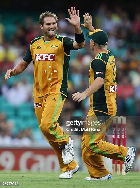 Ryan Harris of Australia celebrates with David Warner after taking the wicket of Runako Morton of the West Indies during the Twenty20 International...