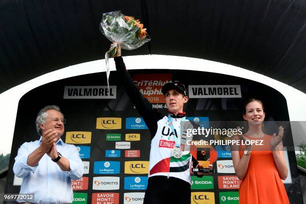Ireland's Daniel Martin celebrates on the podium after winning the fifth stage of the 70th edition of the Criterium du Dauphine cycling race between...