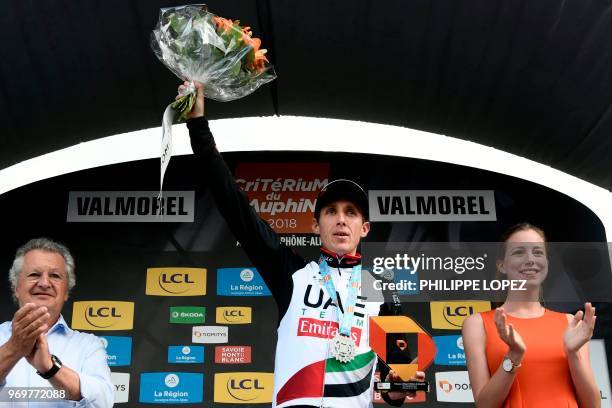Ireland's Daniel Martin celebrates on the podium after winning the fifth stage of the 70th edition of the Criterium du Dauphine cycling race between...