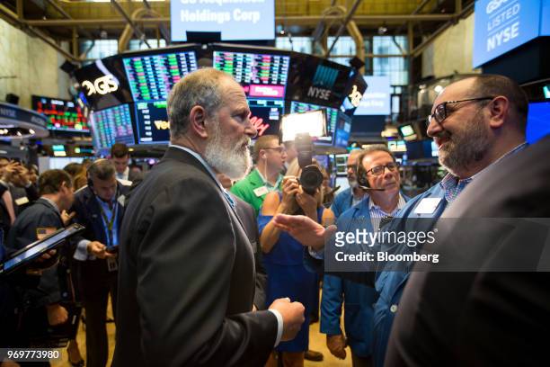 David Cote, chief executive officer of GS Acquisition Holdings Corp., center left, speaks with a trader during the company's initial public offering...