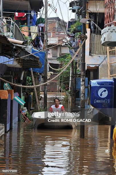 Photo taken February 18, 2010 shows floodwater from southern mountain areas outside Jakarta submerging a street in the capital. It has been the...