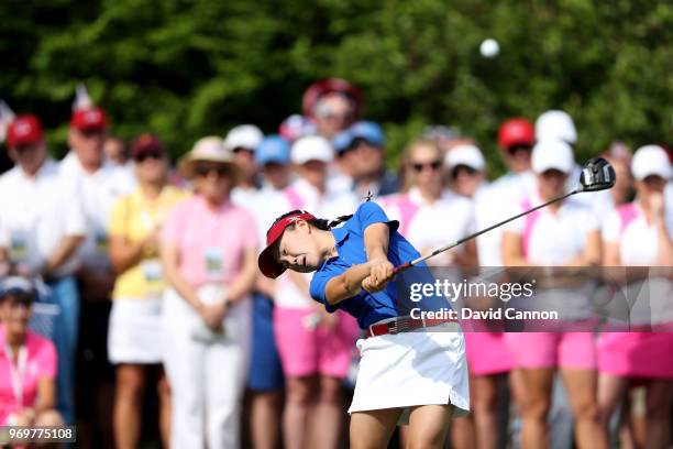 Lucy Li of the United States plays her tee shot on the first hole in her match with Jennifer Kupcho against Sophie Lamb and Olivia Mehaffey of the...