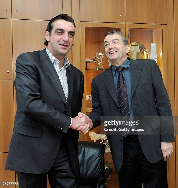 Ralf Minge and general secretary of the DFB Wolfgang Niersbach shake hands during a photocall at the German Football Association on February 23, 2010...