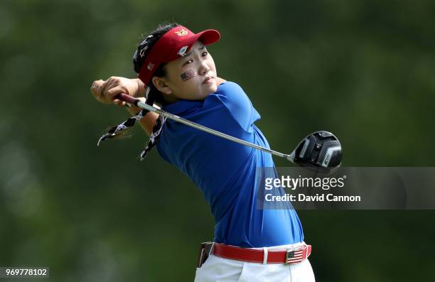 Lucy Li of the United States plays her tee shot on the sixth hole in her match with Jennifer Kupcho against Sophie Lamb and Olivia Mehaffey of the...