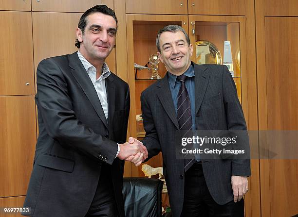 Ralf Minge and General secretary of the DFB Wolfgang Niersbach shake hands during a photocall at the German Football Association on February 23, 2010...