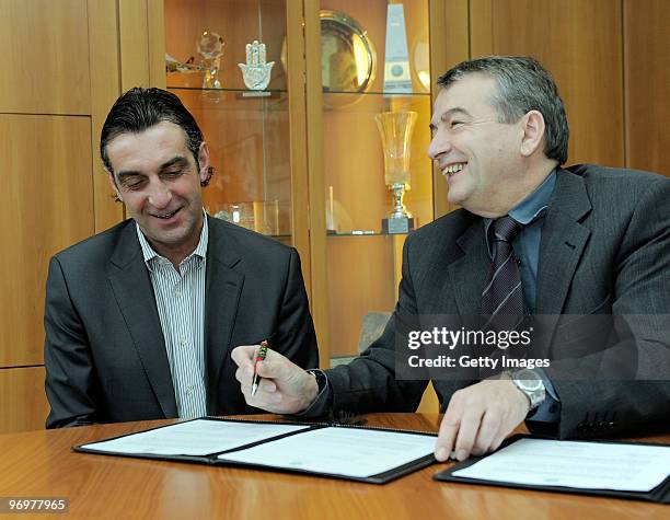 Ralf Minge and general secretary of the DFB Wolfgang Niersbach sign contracts during a photocall at the German Football Association on February 23,...