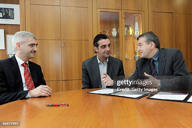 The DFB director for staff and finances Stefan Hans, Ralf Minge and general secretary of the DFB Wolfgang Niersbach sign new contracts during a...