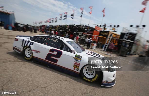 Brad Keselowski, driver of the Miller Lite Ford, drives through the garage area during practice for the Monster Energy NASCAR Cup Series Firekeepers...