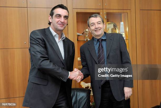 Ralf Minge and general secretary of the DFB Wolfgang Niersbach shake hands during a photocall at the German Football Association on February 23, 2010...