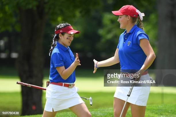 Jennifer Kupcho of the United States celebrates with Lucy Li after a putt on the ninth green during four-ball matches on day one of the 2018 Curtis...