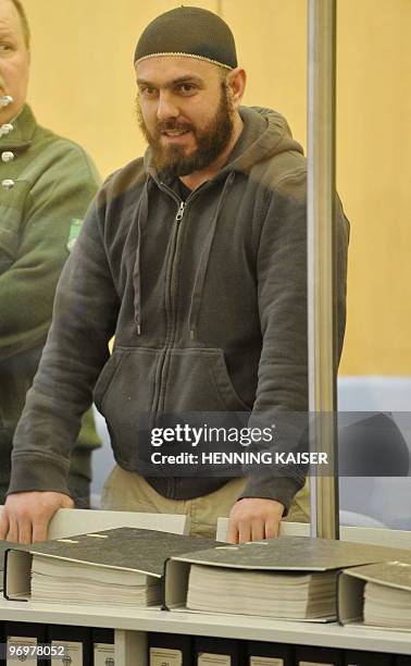 German defendant Adem Yilmaz stands in the high-security courtroom of the superior regional tribunal in the western city of Duesseldorf, on February...