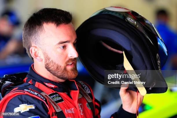 Austin Dillon, driver of the Dow Salutes Veterans Chevrolet, stands by his car during practice for the Monster Energy NASCAR Cup Series Firekeepers...