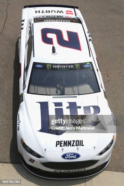 Brad Keselowski, driver of the Miller Lite Ford, drives through the garage area during practice for the Monster Energy NASCAR Cup Series Firekeepers...