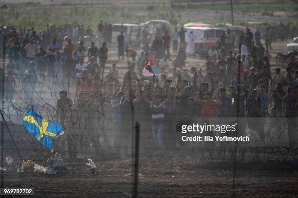 Palestinians protest by the Israel-Gaza border during long day of clashes with Israeli troops on June 8, 2018 in near Nahal Oz, Israel. Naksa is...