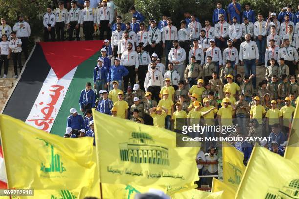 Lebanese Shiite Muslims carry flags of the Shiite Hezbollah movement and other flags and banners,during commemorations marking al-Quds day in the...
