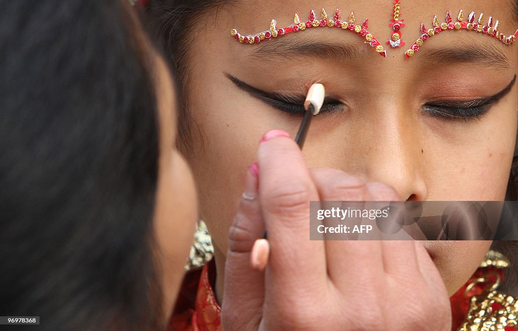 A Newari girl gets final touches from he