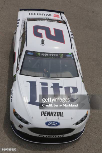 Brad Keselowski, driver of the Miller Lite Ford, drives through the garage area during practice for the Monster Energy NASCAR Cup Series Firekeepers...