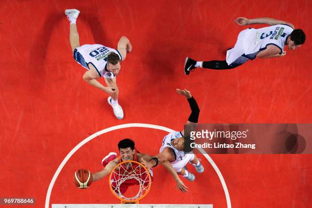 Yu Changdong of China drives to the basket against David Andersen of Australia during the 2018 Sino-Australian Men's Internationl Basketball...