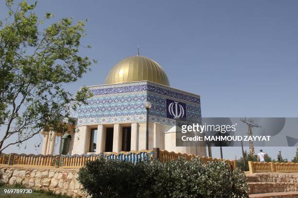 A replica of the Dome of the Rock, emblazoned with the emblem of the Islamic Republic of Iran, is photographed on June 8, 2018 at the "Garden of...