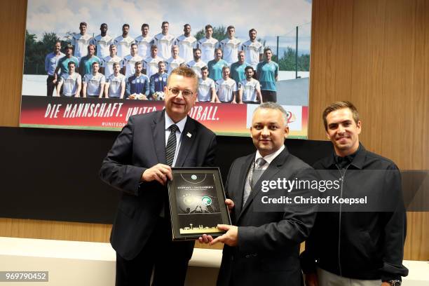 Reinhard Grindel, DFB president and Philipp Lahm, amabassador of "United for Football" application for Euro 2024 hand out a present to Adel Ezzat,...
