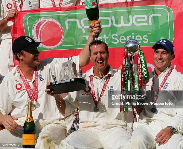 England captain Michael Vaughan gets a champagne soaking from teammate Andrew Flintoff as England celebrate winning the Test series against West...