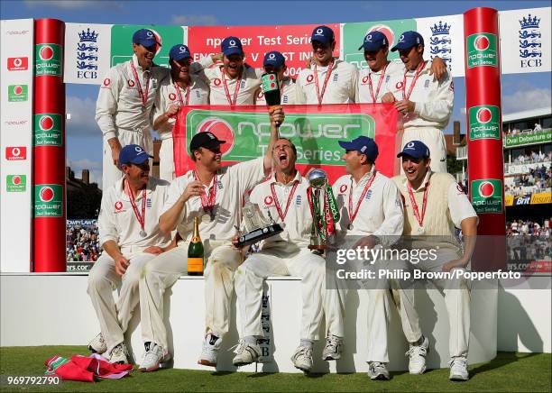 England captain Michael Vaughan gets a champagne soaking from teammate Andrew Flintoff as England celebrate winning the Test series against West...