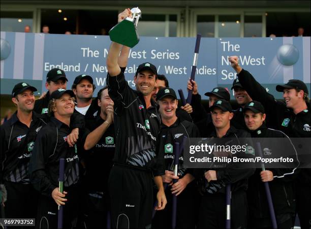 New Zealand captain Stephen Fleming holds the trophy as New Zealand celebrate winning the NatWest Series Final against West Indies at Lord's Cricket...