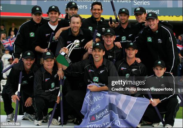 New Zealand captain Stephen Fleming holds the trophy as New Zealand celebrate winning the NatWest Series Final against West Indies at Lord's Cricket...