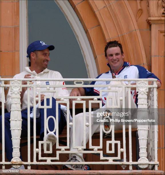 Nasser Hussain of England enjoys a celebratory drink with teammate Andrew Strauss on the dressing room balcony after England had won the 1st Test...