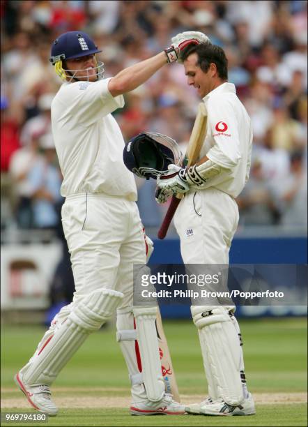 England captain Michael Vaughan is congratulated on his century by teammate Andrew Flintoff during the 1st Test match between England and West Indies...