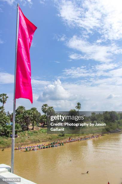 red flag over the sangkae river boat races in battambang - cambodia water festival stock pictures, royalty-free photos & images