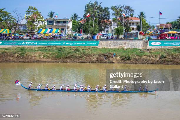 blue longboat moving along the sangkae river in battambang - galleon stock pictures, royalty-free photos & images
