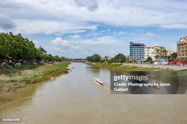 boats racing along the sangkae river at the water festival in battambang - cambodia water festival stock pictures, royalty-free photos & images