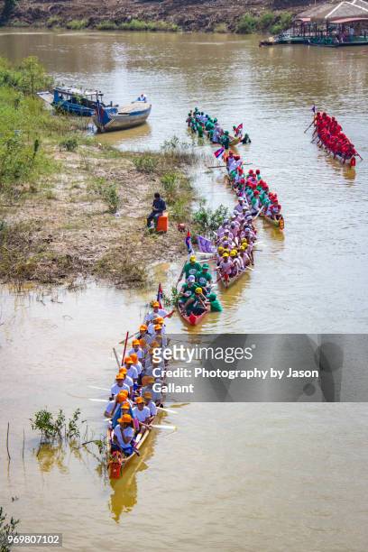 boats lining up in the sangkae river for the water festival boat races. - cambodia water festival stock pictures, royalty-free photos & images